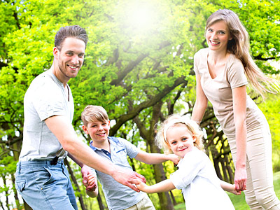 Eine Familie spielt in einem grünen Park.
